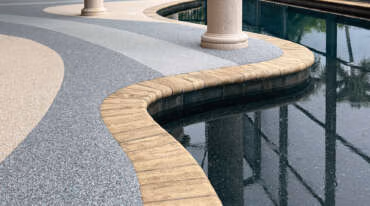 Rubberized Coatings vs. Pavers vs. Travertine: Which Is Right for Your Backyard?